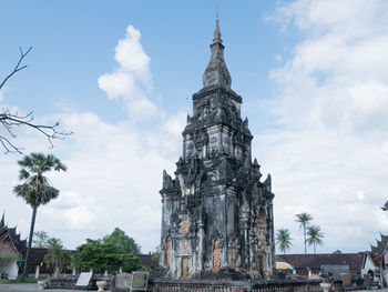 Low angle view of church against cloudy sky