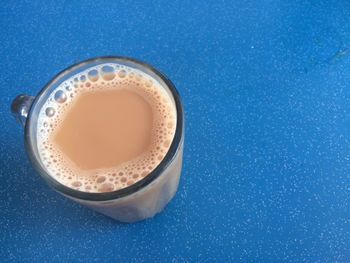 High angle view of coffee on blue background