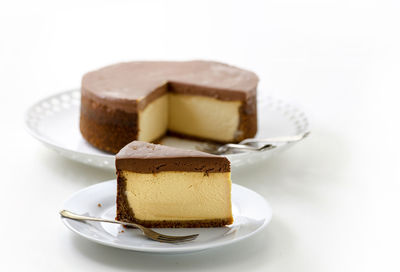 Close-up of dessert in plate against white background