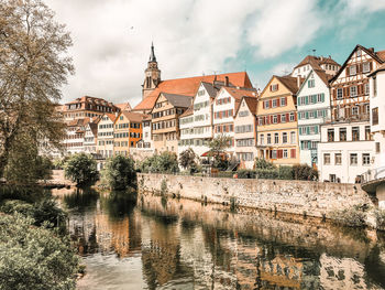 Buildings in city against cloudy sky