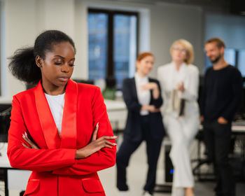 Portrait of young woman standing in office