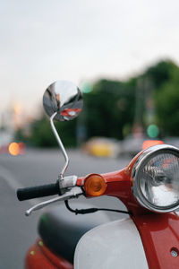 Close-up of motor scooter on road