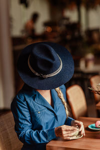 Rear view of women wearing hat at cafe 