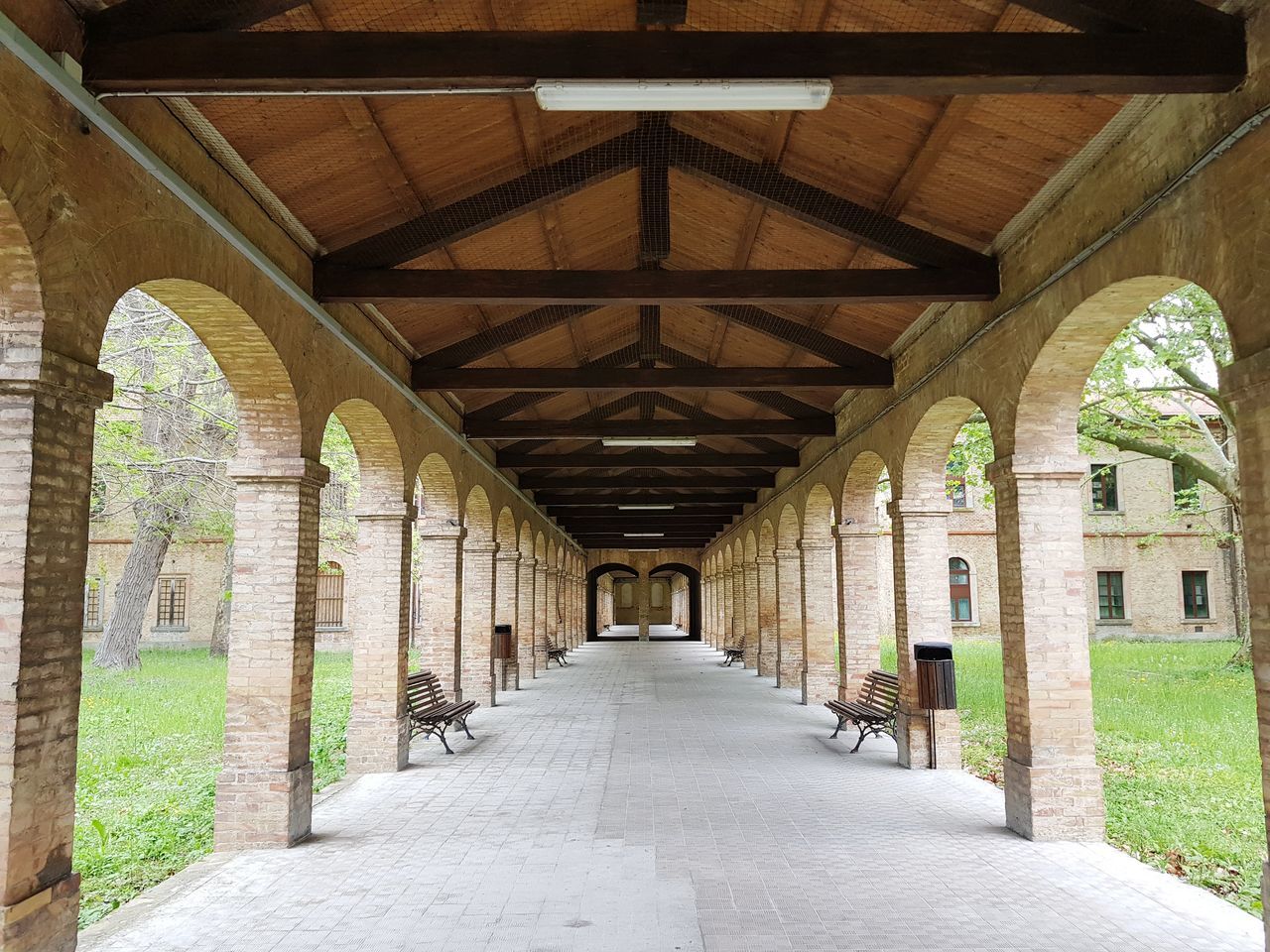 EMPTY CORRIDOR OF BUILDING WITH COLONNADE