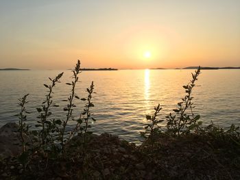 Scenic view of lake against sky during sunset