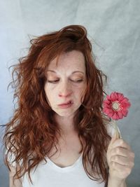 Portrait of young woman holding flower