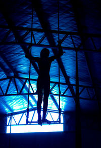 Low angle view of silhouette person standing on floor