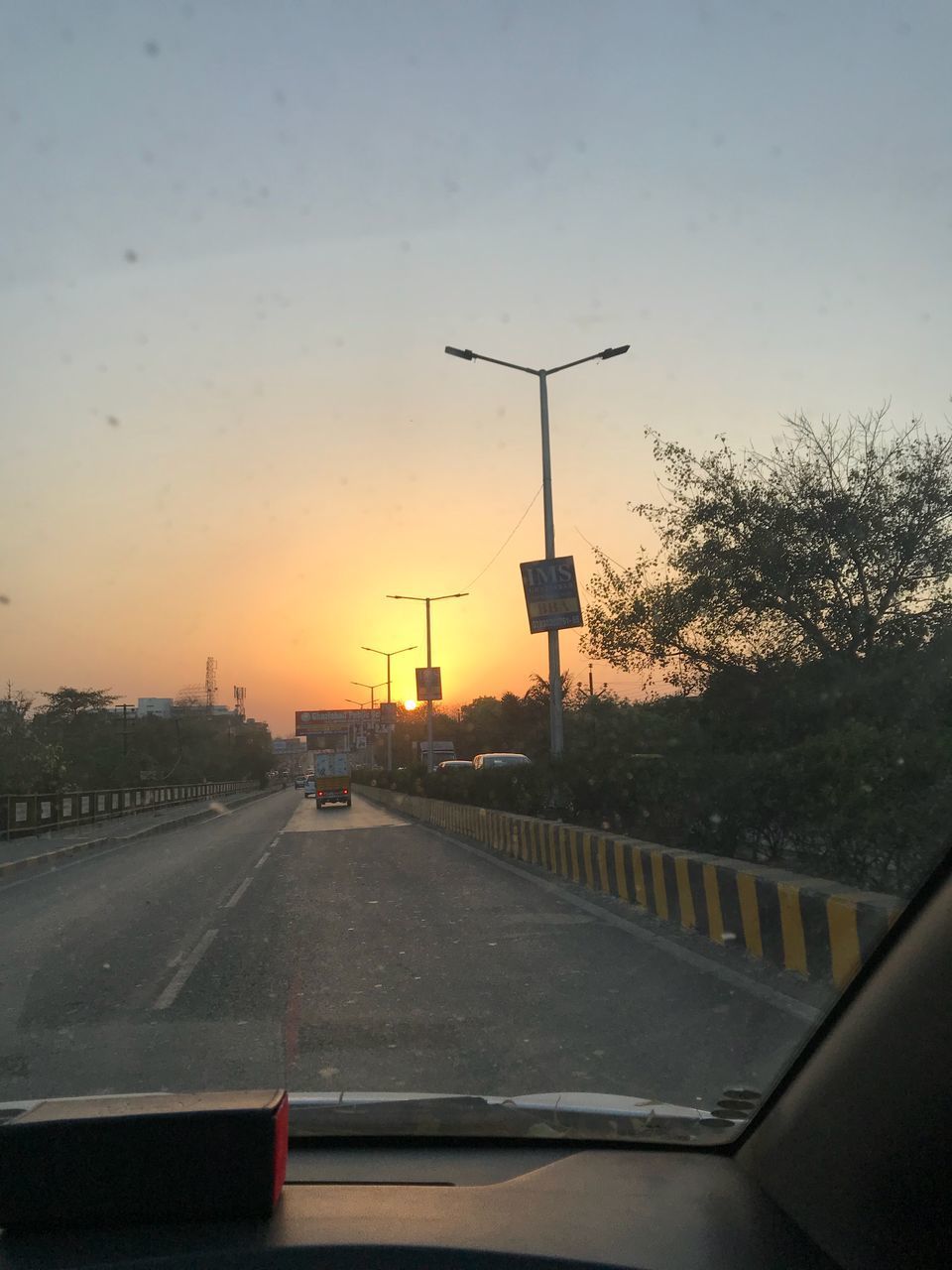 CARS ON ROAD AGAINST SKY DURING SUNSET