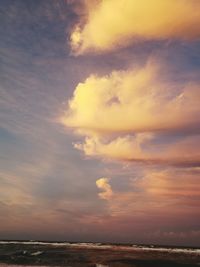 Scenic view of sea against dramatic sky during sunset