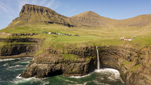 Scenic view of waterfall against sky