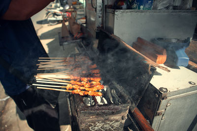 Man working on barbecue grill
