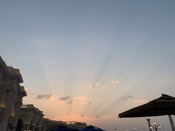 Low angle view of silhouette buildings against sky at sunset