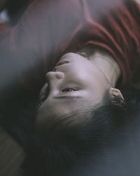 High angle view of young woman lying on bed at home