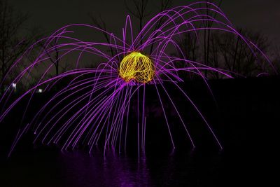 Low angle view of firework display at night