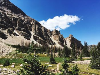 Scenic view of mountains against blue sky