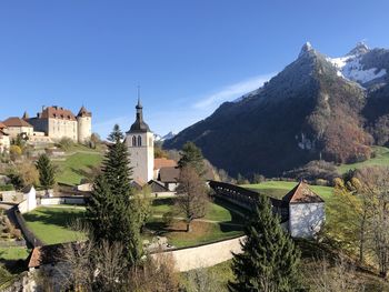 Panoramic view of buildings and mountains against clear sky