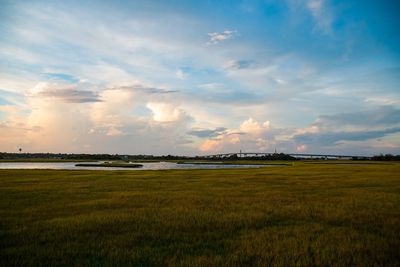 Scenic view of field against sky during sunset