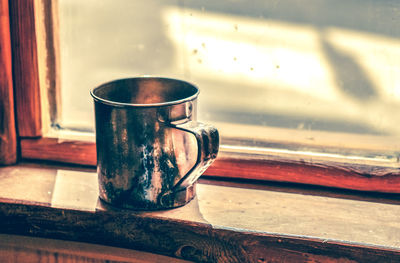 Close-up of rusty glass on table