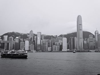 Boats in river with buildings in background