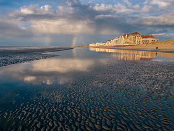 Scenic view of beach against sky in city