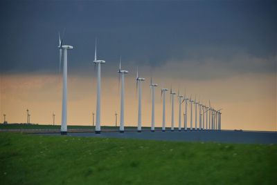 Built structure on field against sky wind turbine