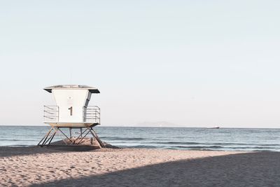 Lifeguard hut on beach against clear sky