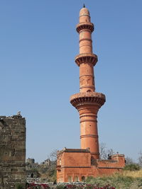 Low angle view of historical building against clear blue sky