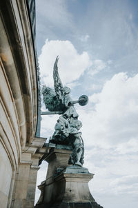 Low angle view of statue against cloudy sky