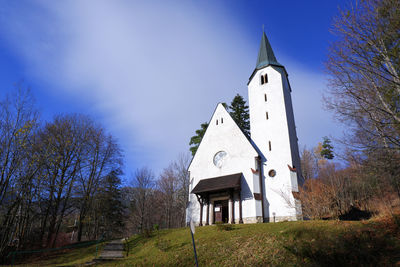 Low angle view of building and trees against sky