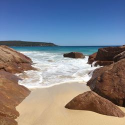 Scenic view of sea against clear blue sky