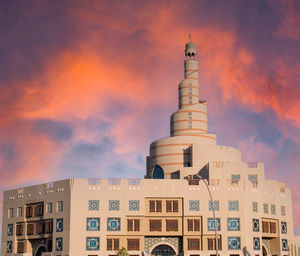 Low angle view of building against cloudy sky