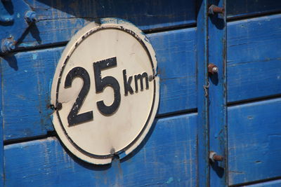 Close-up of number on blue door