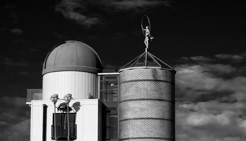 Low angle view of industrial building against sky