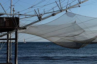 Sailboat sailing on sea against sky