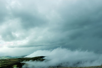 Scenic view of sea against storm clouds