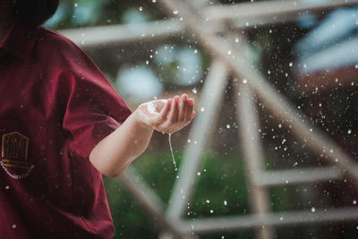 Midsection of woman holding wet glass