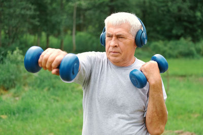 Portrait of young woman exercising in park