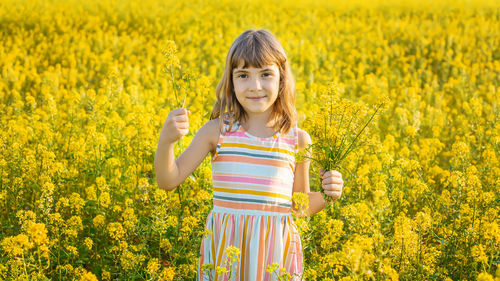 Smiling girl holding bunch of flowers