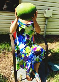 Midsection of woman holding umbrella