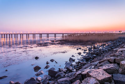 Scenic view of sea against clear sky during sunset