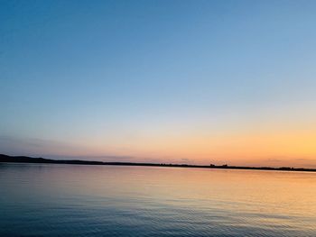 Scenic view of sea against clear sky during sunset