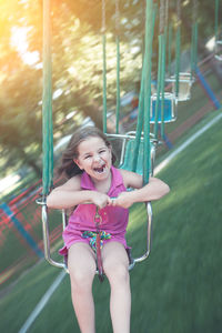 Portrait of smiling girl on slide at playground