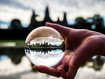 Close-up of hand holding crystal ball