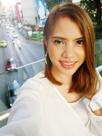 Portrait of smiling young woman in car