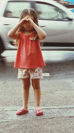 Full length of girl standing in car