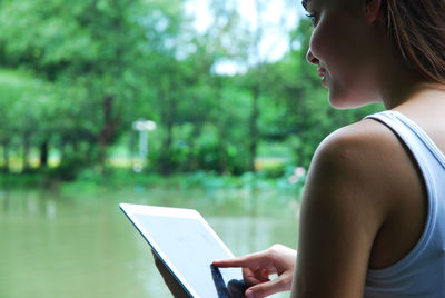 Midsection of woman using mobile phone