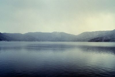 Scenic view of lake with mountains in background