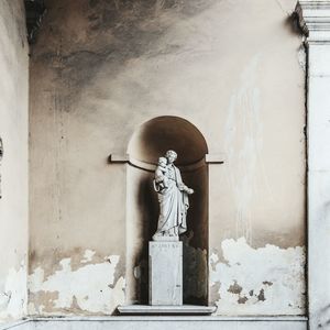 Statue against building