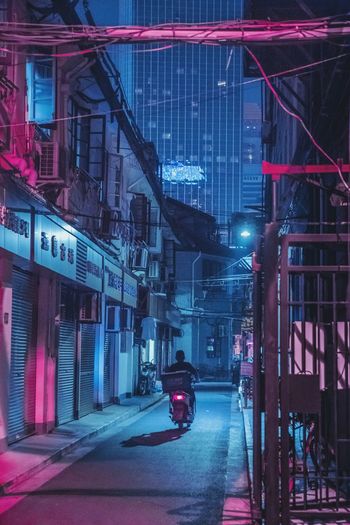 CARS ON ILLUMINATED ROAD AT NIGHT