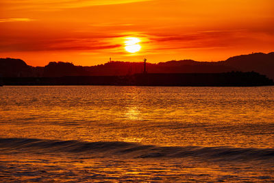 Scenic view of sea against romantic sky at sunset